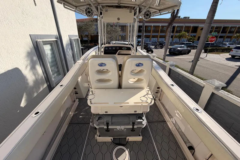 Slide: The Image of 2004 Grady White 273 boat interior with seating and console, docked near a street. - 36