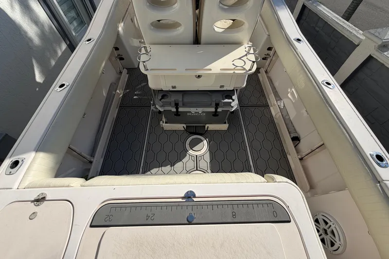 Slide: The Image of 2004 Grady White 273 boat interior with seating, storage, and fishing rod holders. - 37