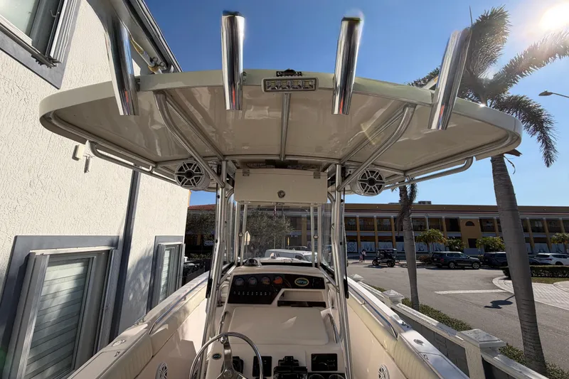 Slide: The Image of 2004 Grady White 273 boat with T-top and rod holders, parked near palm trees. - 39