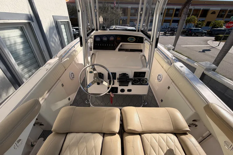 Slide: The Image of 2004 Grady White 273 boat interior with steering wheel and seating area. - 46