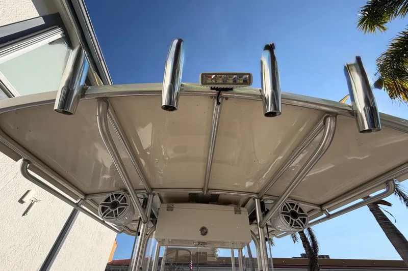 Slide: The Image of 2004 Grady White 273 boat top with rod holders and speakers under clear sky. - 49