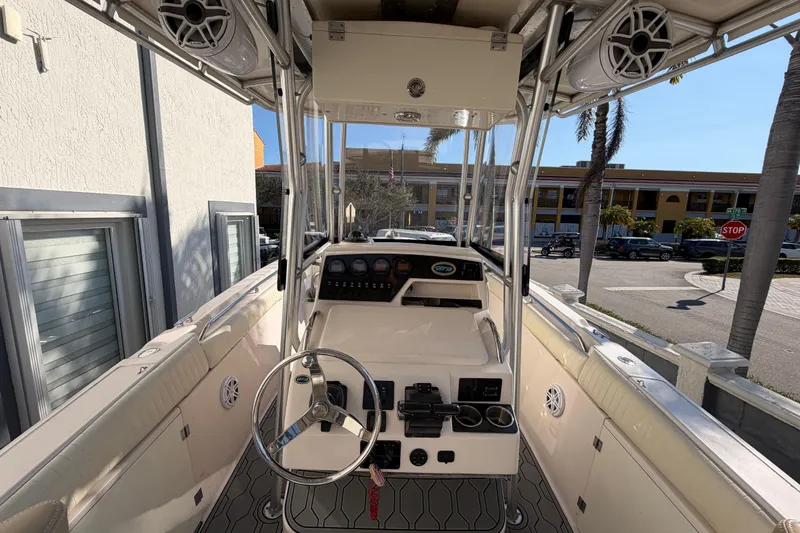 Slide: The Image of 2004 Grady White 273 boat interior with steering wheel and control panel. - 51
