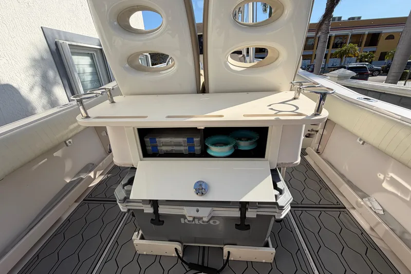 Slide: The Image of 2004 Grady White 273 boat interior with storage compartments and cooler. - 55