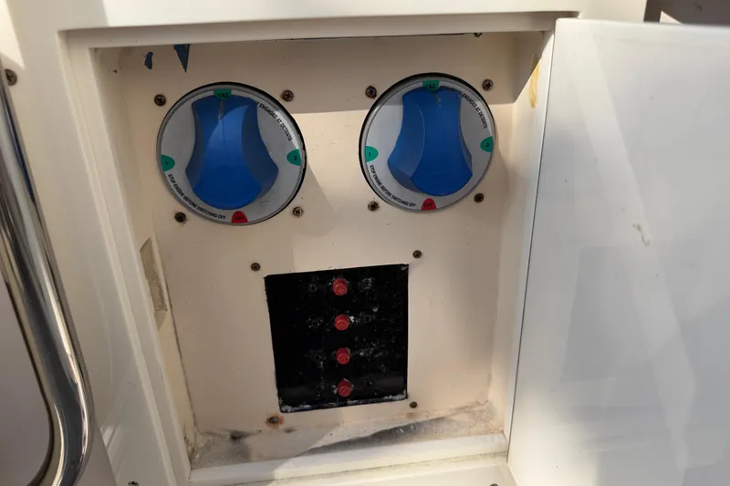 Slide: The Image of Control panel of a 2004 Grady White 273 boat with switches and dials. - 57