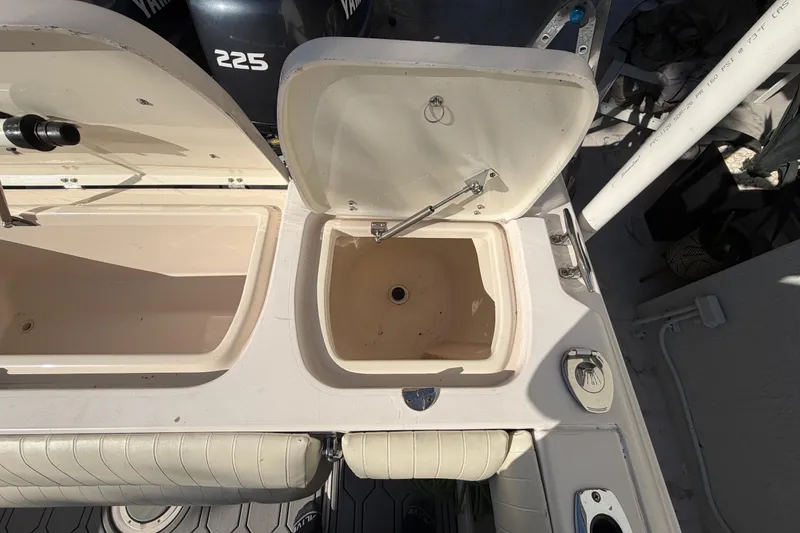 Slide: The Image of 2004 Grady White 273 boat storage compartments and Yamaha 225 engine. - 58