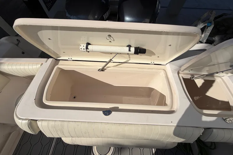 Slide: The Image of Open storage compartment on a 2004 Grady White 273 boat, showing interior details. - 59