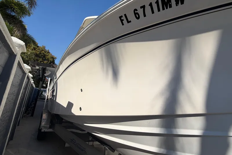 Slide: The Image of 2004 Grady White 273 boat on trailer, side view with registration number visible. - 6