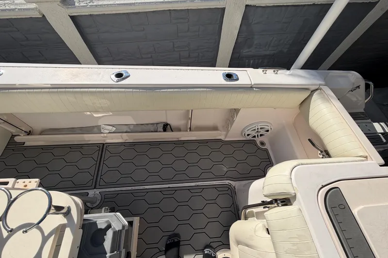 Slide: The Image of 2004 Grady White 273 boat interior with cushioned seating and hexagonal floor design. - 65