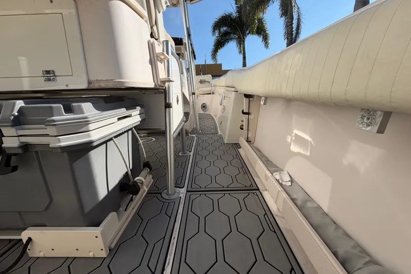Slide: The Image of 2004 Grady White 273 boat interior with storage and seating, featuring hexagonal flooring design. - 68