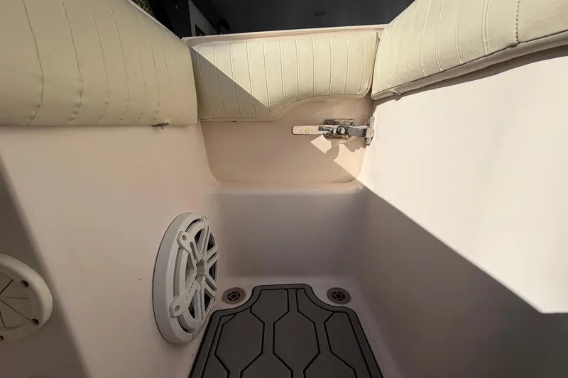 Slide: The Image of Interior of a 2004 Grady White 273 boat, featuring cushioned seating and speaker. - 69