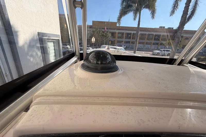 Slide: The Image of 2004 Grady White 273 boat dashboard with compass, city street view. - 70