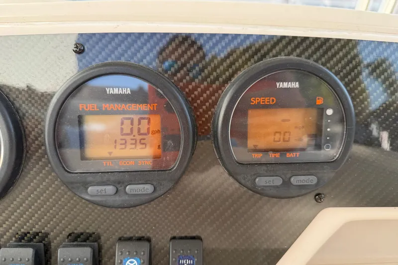 Slide: The Image of Yamaha fuel management and speed gauges on 2004 Grady White 273 boat dashboard. - 79