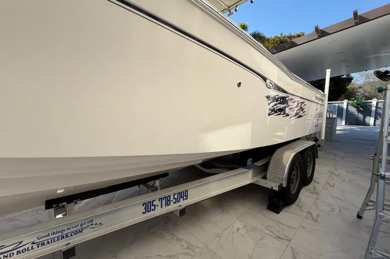 Slide: The Image of 2004 Grady White 273 boat on trailer, parked in a tiled driveway. - 8