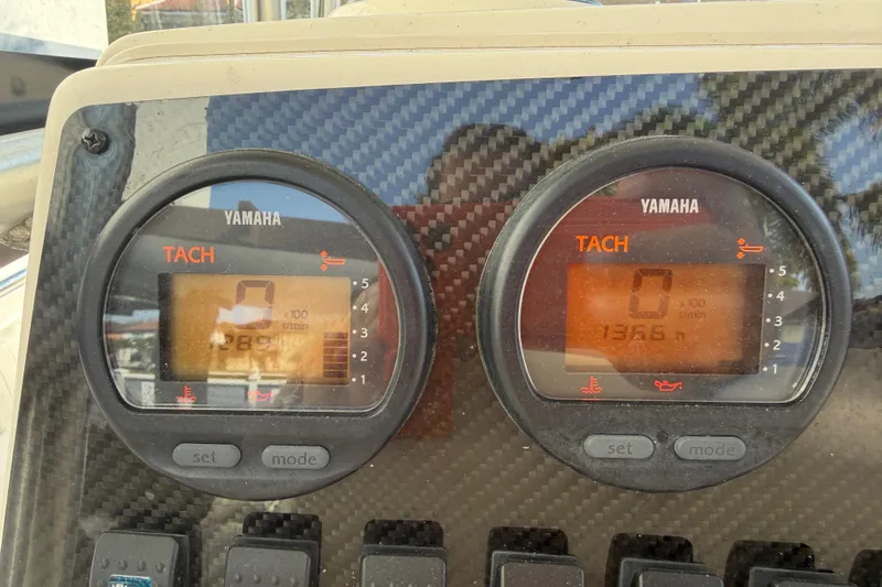 Slide: The Image of Yamaha tachometers on 2004 Grady White 273 boat dashboard, displaying engine RPM and hours. - 80