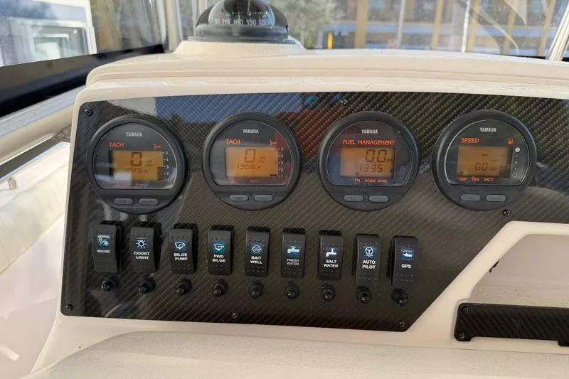 Slide: The Image of Dashboard of 2004 Grady White 273 boat with Yamaha gauges and control switches. - 82