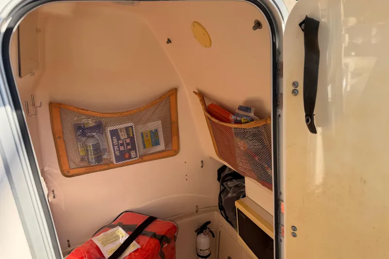 Slide: The Image of Interior cabin of 2004 Grady White 273 boat with storage nets and safety equipment. - 83