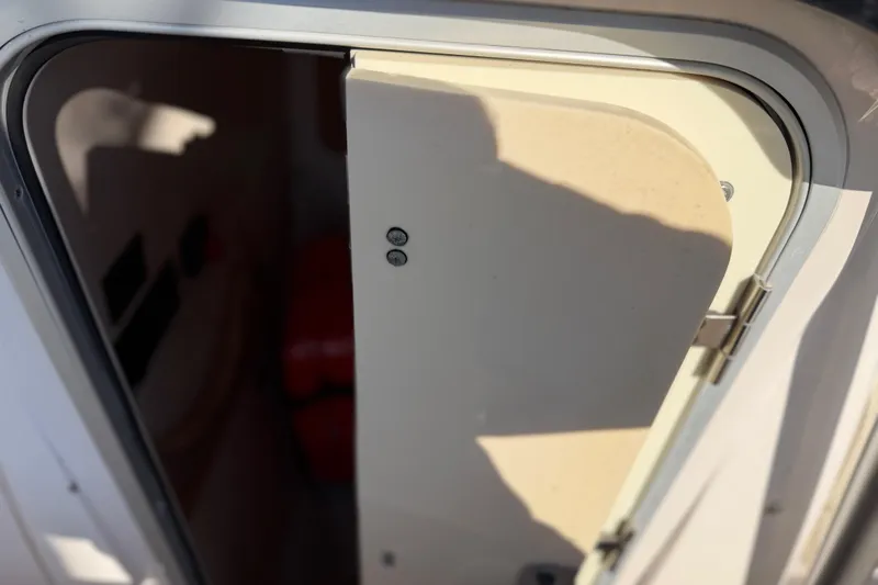 Slide: The Image of 2004 Grady White 273 boat cabin door partially open, showing interior shadows. - 85