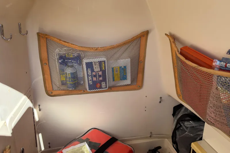 Slide: The Image of Interior storage of 2004 Grady White 273 boat with mesh pockets and supplies. - 87