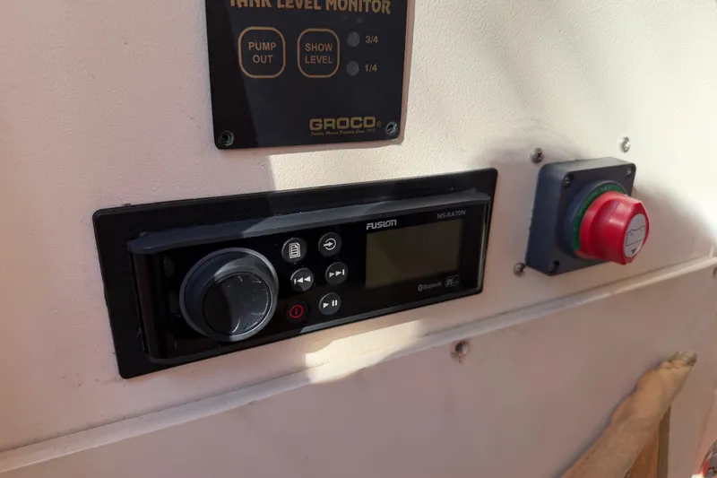 Slide: The Image of Control panel on 2004 Grady White 273 boat with Fusion audio system and tank level monitor. - 88