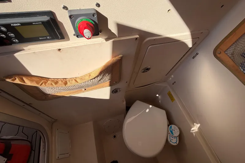 Slide: The Image of Interior of 2004 Grady White 273 boat with toilet and control panel. - 90