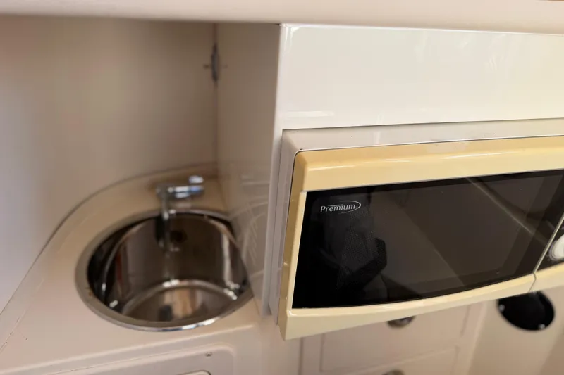 Slide: The Image of 2004 Grady White 273 boat interior with sink and microwave. - 94