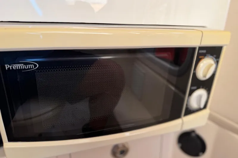 Slide: The Image of Microwave oven inside 2004 Grady White 273 boat kitchen area. - 95