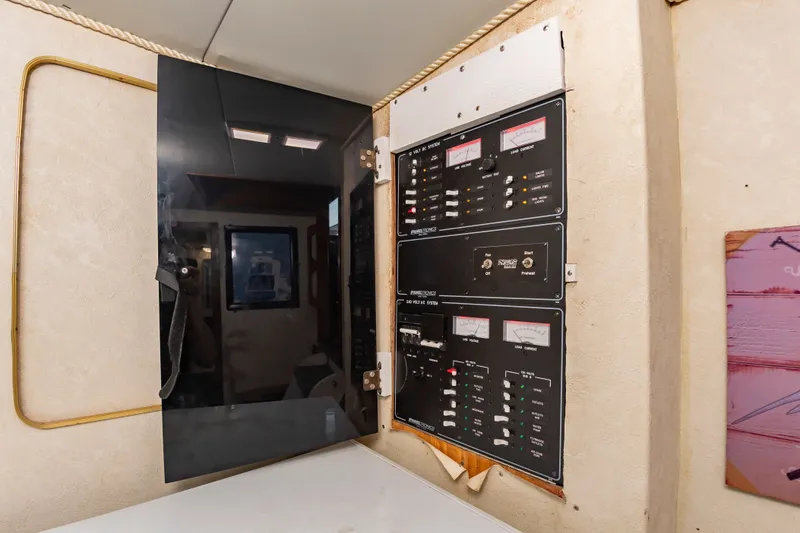 Slide: The Image of Electrical control panel in a boat with multiple switches and indicators. - 38