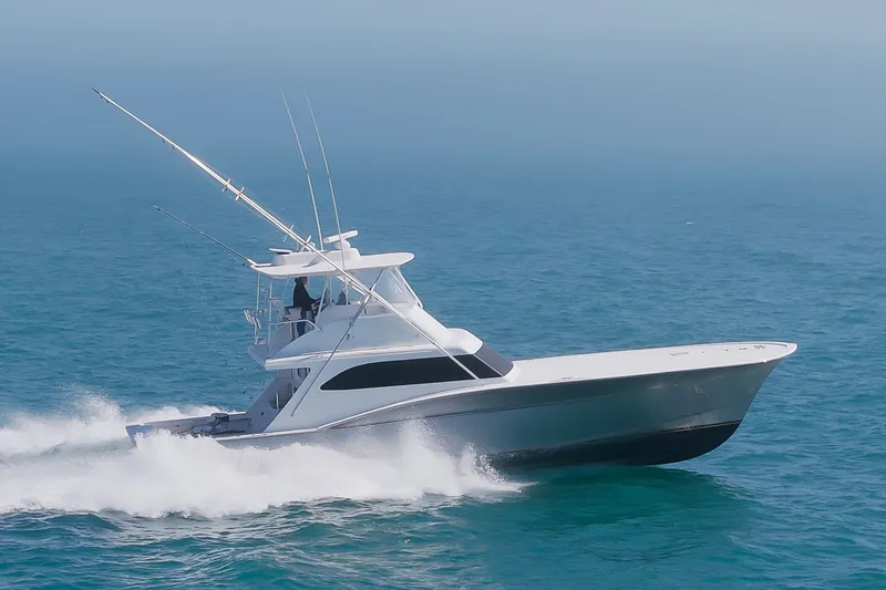 Slide: The Image of A 2000 Custom Carolina Terry Guthrie Sportfish speeds across the blue sea. - 2