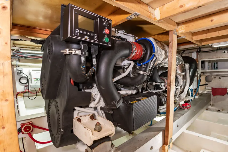 Slide: The Image of The engine room of a 2000 Custom Carolina Terry Guthrie Sportfish features a large engine with control panel. - 27