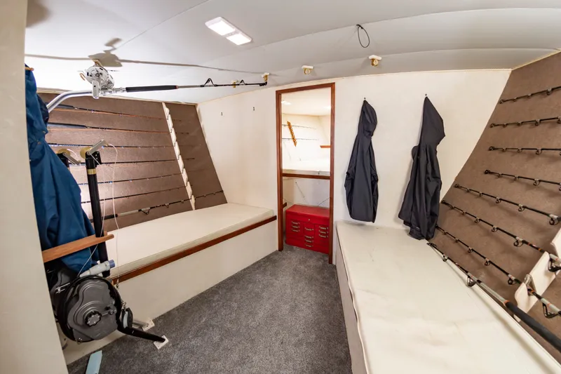 Slide: The Image of Interior of a sportfishing yacht with two cushioned benches and fishing rod holders. - 40