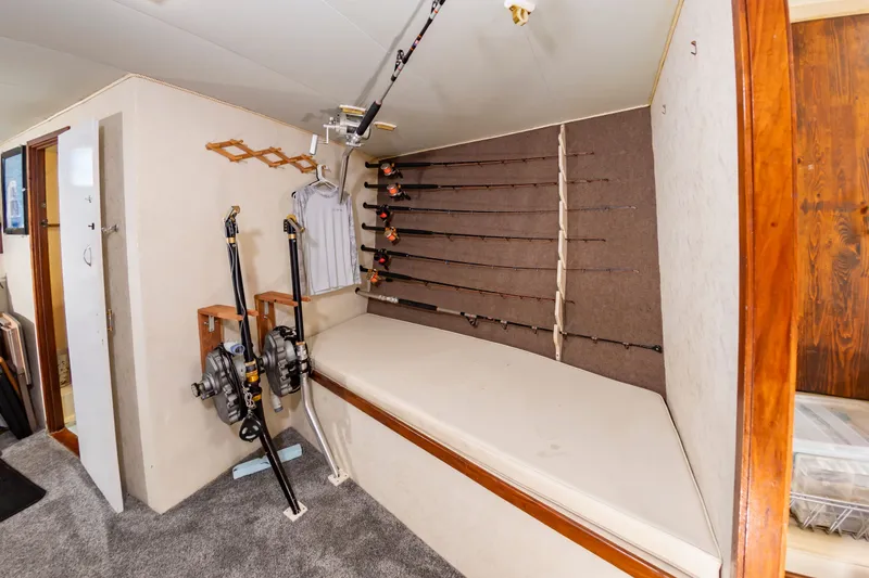 Slide: The Image of Fishing rod storage in a boat with multiple mounted rods and a cushioned bench. - 41