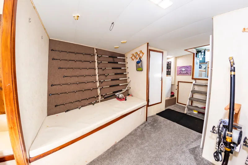 Slide: The Image of The interior of a sportfishing boat features a wall with fishing rod holders and a staircase. - 42