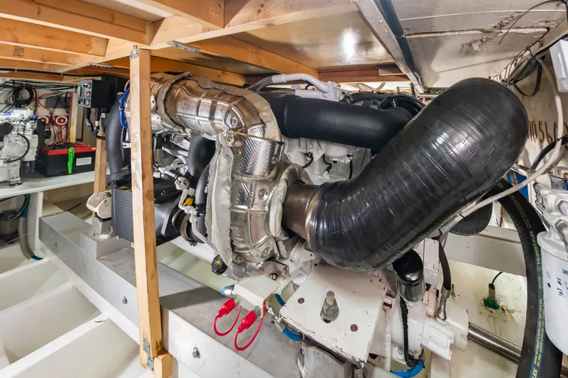 Slide: The Image of Engine room of a 2000 Custom Carolina Terry Guthrie Sportfish with visible engines and pipes. - 37