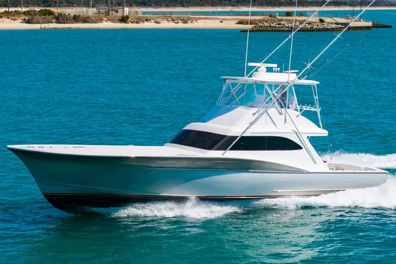 Slide: The Image of A sleek 2000 Custom Carolina sportfish boat glides swiftly over the blue water. - 4