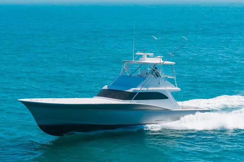 Slide: The Image of A 2000 Custom Carolina Terry Guthrie Sportfish cruising swiftly over the blue sea. - 46
