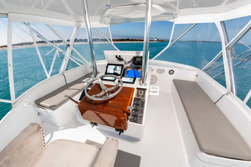 Slide: The Image of The cockpit of a 2000 Custom Carolina Terry Guthrie Sportfish with helm, instruments, and seating. - 15