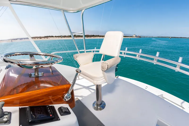 Slide: The Image of The image shows the helm of a 2000 Custom Carolina Terry Guthrie Sportfish with a white captain's chair. - 19
