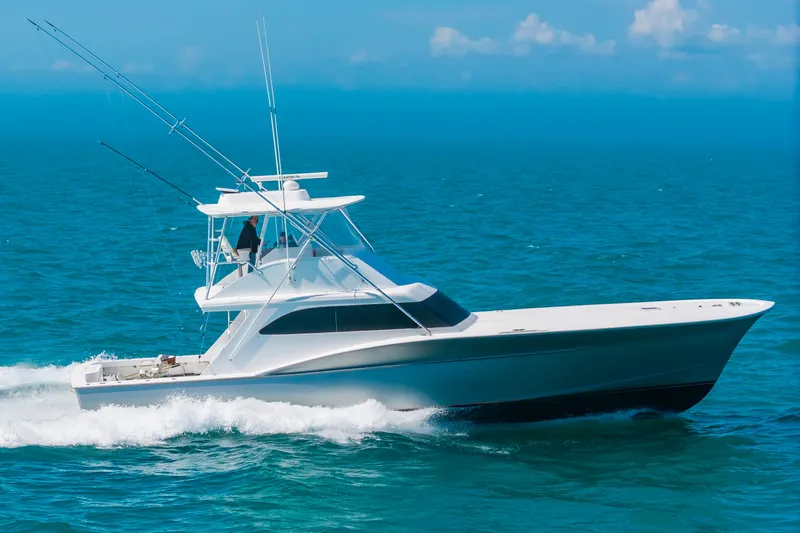 Slide: The Image of A sleek sportfish boat speeds across the blue sea, featuring clean lines and a tall helm. - 47