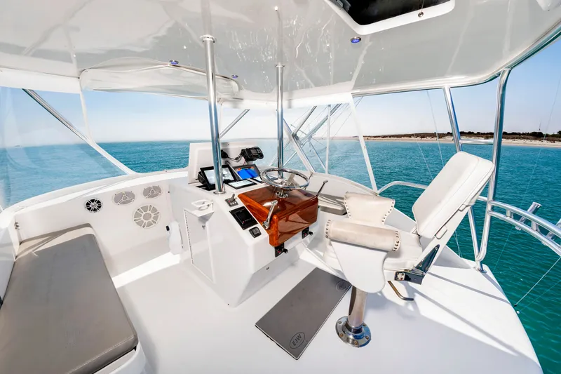 Slide: The Image of The image shows the helm of a 2000 Custom Carolina Terry Guthrie Sportfish with a view of the sea. - 13
