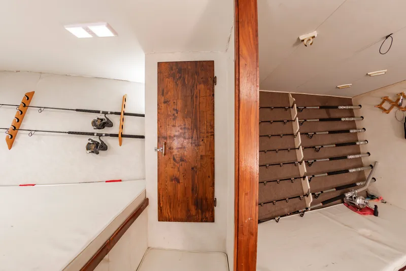Slide: The Image of Fishing rod storage in a sportfish boat with wooden door and white walls. - 43