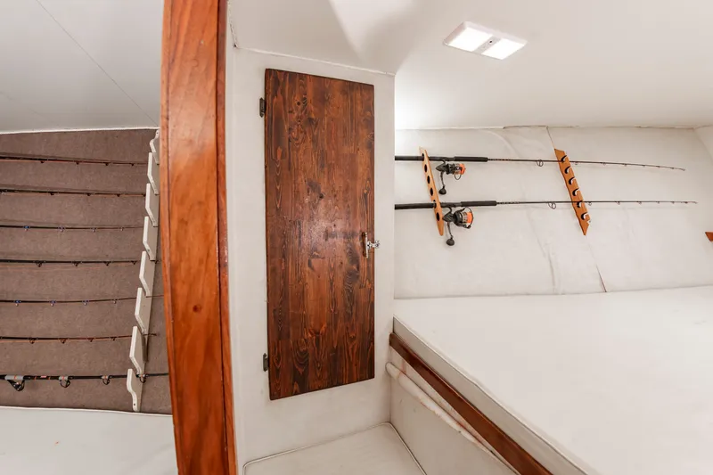 Slide: The Image of Interior of a sportfish boat with fishing rod holders and a wooden door. - 44