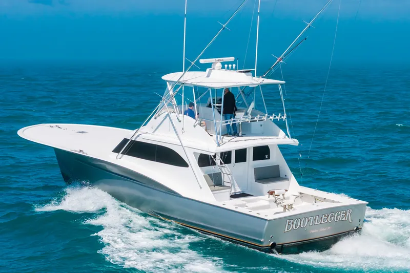 Slide: The Image of A 2000 Custom Carolina Terry Guthrie Sportfish cruising on open water. It features an elevated helm. - 7