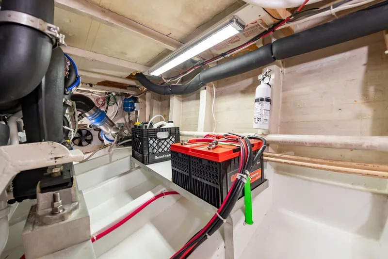 Slide: The Image of The engine room of a 2000 Custom Carolina Terry Guthrie Sportfish with batteries and wiring. - 30