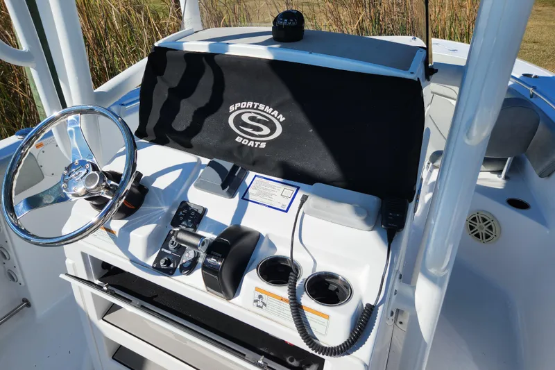 Slide: The Image of 2020 Sportsman Open 232 Center Console boat dashboard with steering wheel and controls. - 10