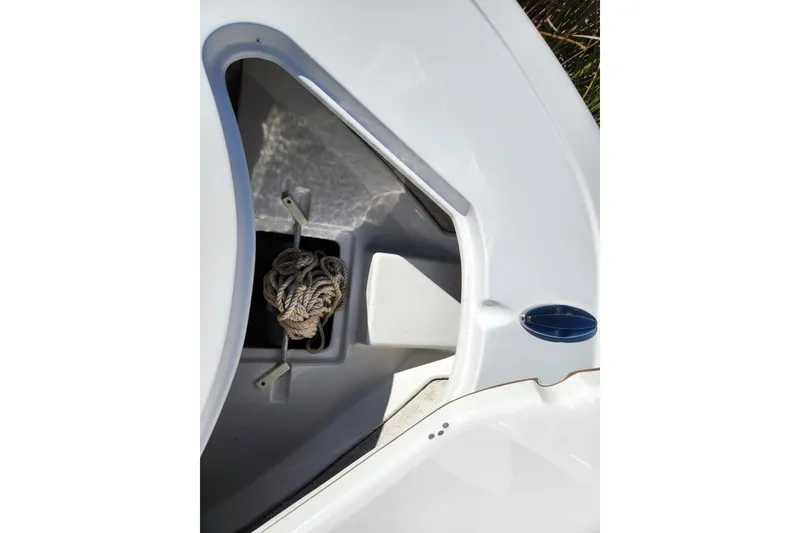Slide: The Image of 2020 Sportsman Open 232 Center Console boat anchor storage compartment with rope. - 18