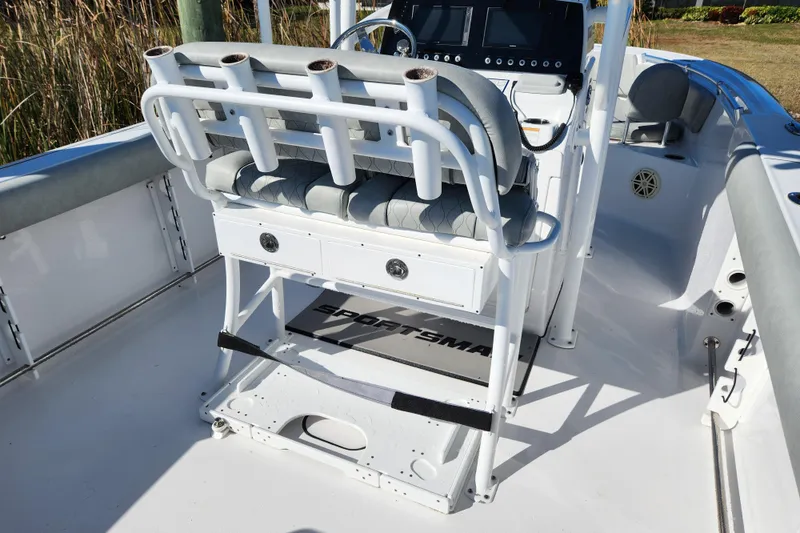 Slide: The Image of 2020 Sportsman Open 232 Center Console boat interior with rod holders and seating. - 3