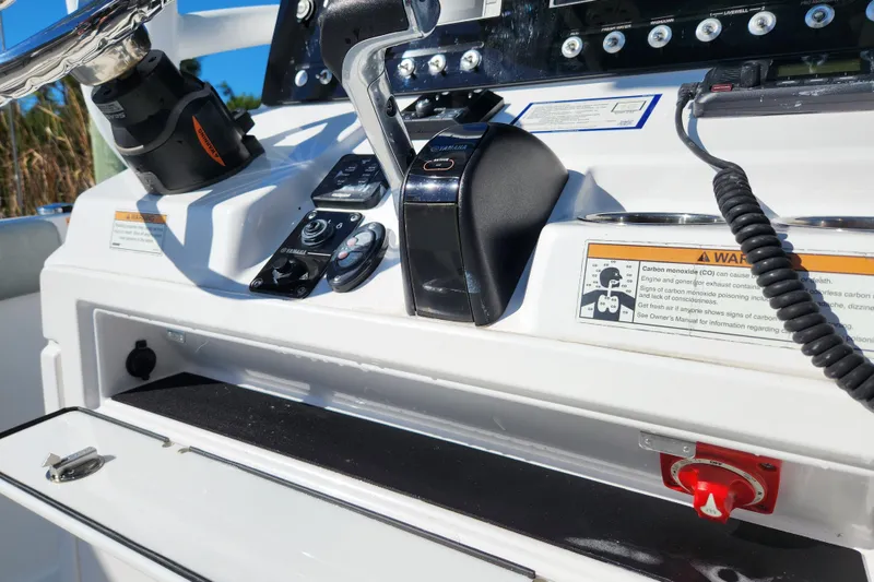 Slide: The Image of 2020 Sportsman Open 232 Center Console dashboard with controls and warning labels. - 9