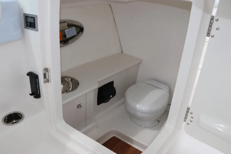 Slide: The Image of 2026 Robalo R257 Dual Console boat compartment with lock and logo. - 24
