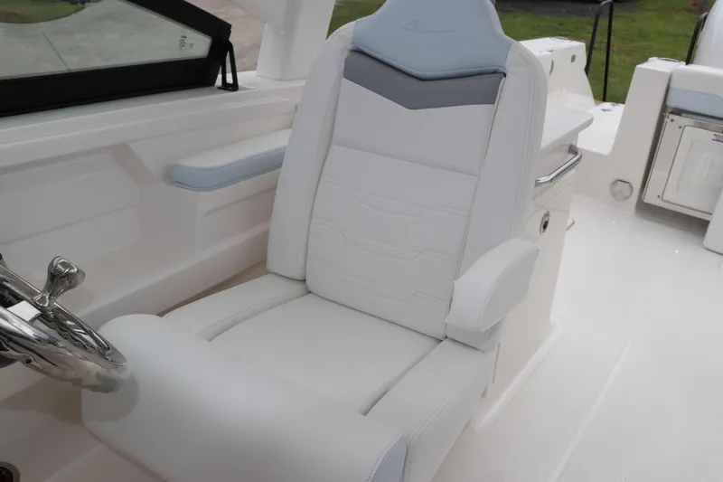 Slide: The Image of 2026 Robalo R257 Dual Console boat interior with compact marine toilet and sink. - 28