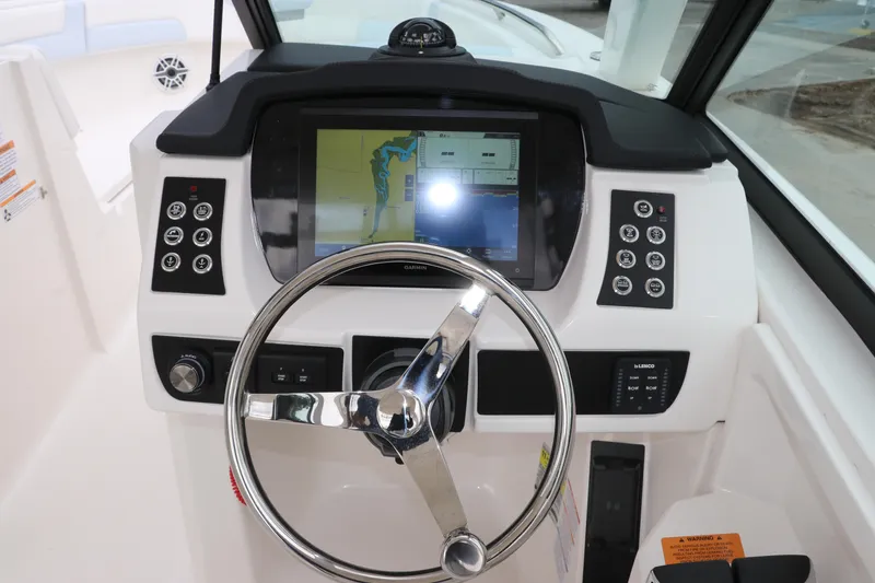 Slide: The Image of 2026 Robalo R257 Dual Console boat speaker and storage compartment detail. - 29